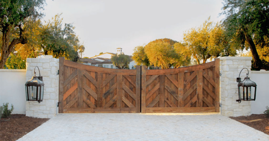 Closed wooden gate with stone pillars.