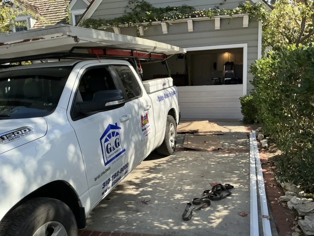 A white service truck parked in a driveway during a house call, representing a reliable expert for spring replacement in Torrance, CA.