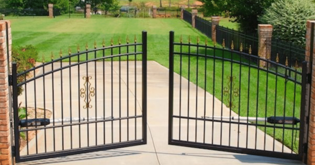 Black iron gate with gold tip details.