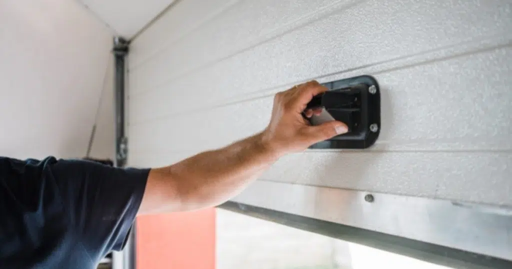 Man pulling garage door release handle