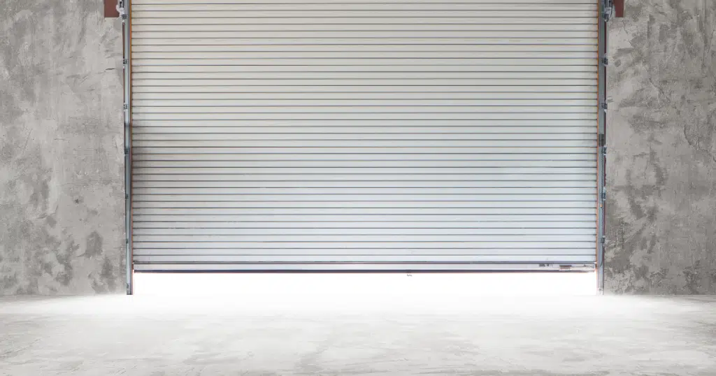 Gray garage door, concrete wall.