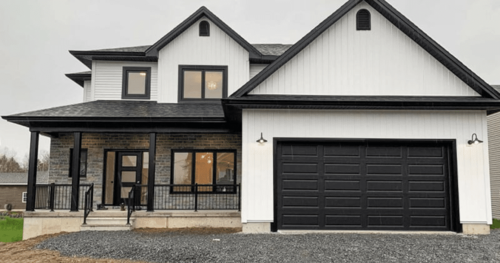 white house exterior with black garage door
